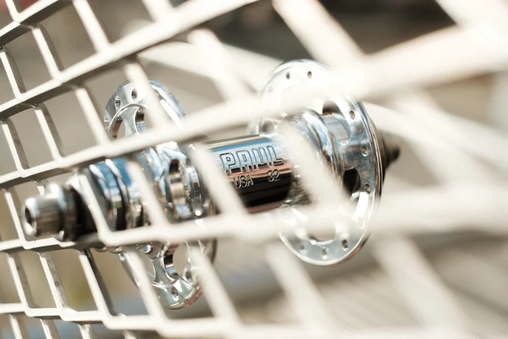 Polished Paul Components hub resting against a pale grid.
