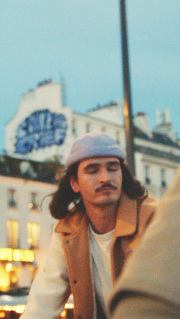 El Fakijoe wearing a grey Béton Ciré hat in the Paris campaign film