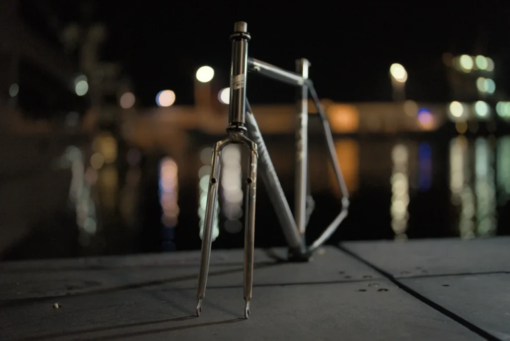 Raw steel Grit frame standing on concrete at night