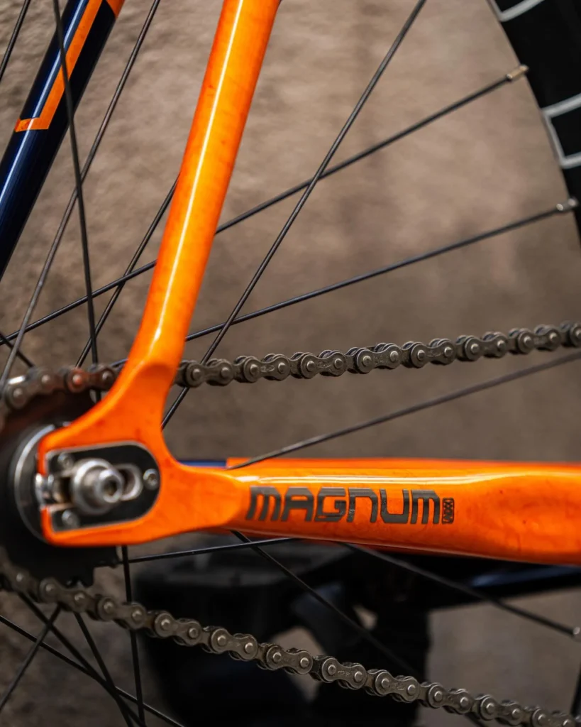 The Magnum chainstay, rear axle and chain in the Lava orange finish