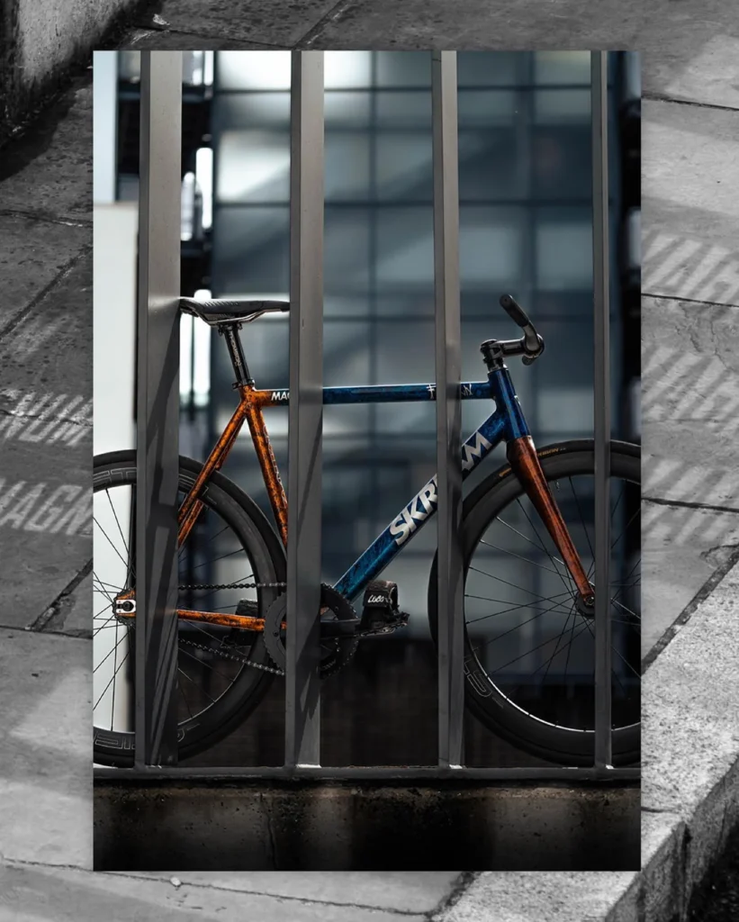 The custom Skream Magnum seen through a grey metal gate in a layered photographic composition