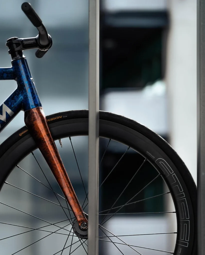 The custom Magnum front wheel, orange fork and blue head tube