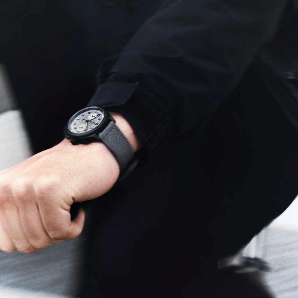 Close-up of the Charlie Paris GRX watch on El Fakijoe’s wrist during the campaign